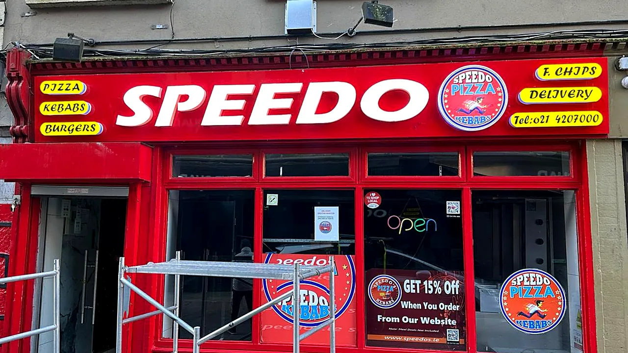 Speedo shopfront in Cork: red fascia with large white SPEEDO letters, logo and yellow menu panels.